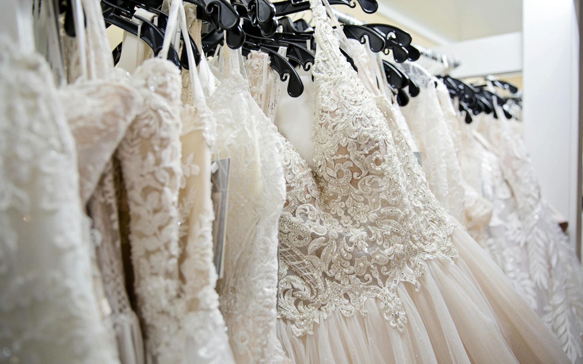 Beautiful lace wedding dresses on display in a bridal boutique, showcasing intricate designs and elegance.